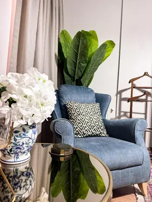 a living room with a blue chair and a table at Modern Furnished Historical House in Istanbul
