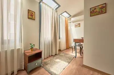 a living room with a table and a window at Modern Furnished Historical House in Istanbul