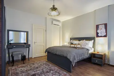 a bedroom with a bed and a table and a piano at Modern Furnished Historical House in Istanbul