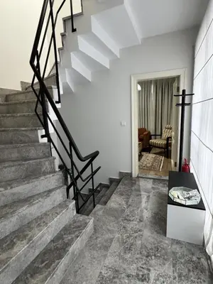 a staircase in a home with white walls and concrete floors at Modern Furnished Historical House in Istanbul