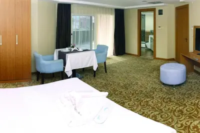 a hotel room with a bed and a table and chairs at Helenapolis Otel in Yalova
