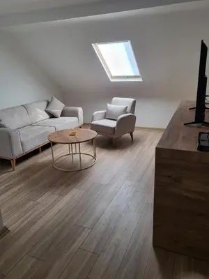 a living room with a couch and a table at Petra Port Hotel in Tuzla