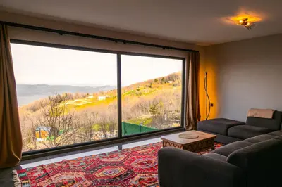 a living room with a large window with a view at PANA Sapanca Lake View in Sapanca