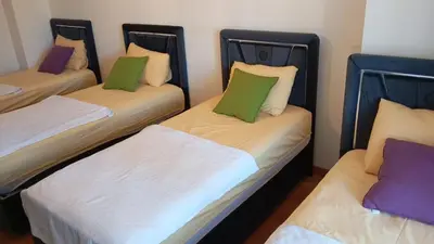 three beds with different colored pillows in a room at Taksim Perfect Residence, 3 bedrooms, pool, sauna, gym in Istanbul