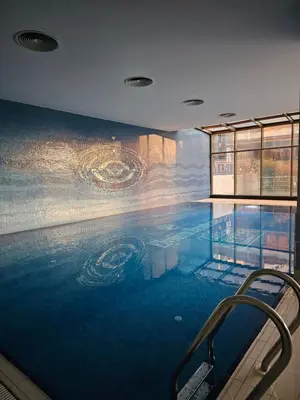 a large swimming pool with a painting on the wall at Taksim Perfect Residence, 3 bedrooms, pool, sauna, gym in Istanbul