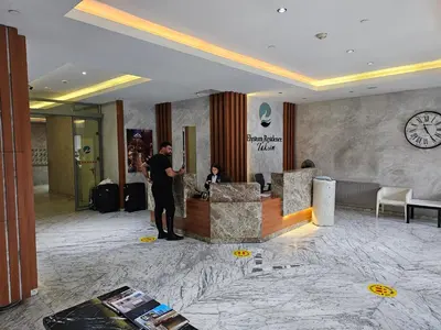 a man standing in the lobby of a hotel at Taksim Perfect Residence, 3 bedrooms, pool, sauna, gym in Istanbul