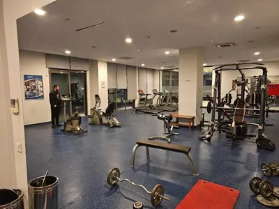 a man standing in a gym with several tread machines at Taksim Perfect Residence, 3 bedrooms, pool, sauna, gym in Istanbul