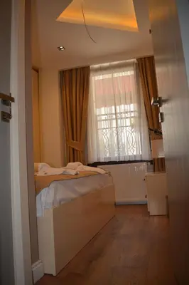 a bedroom with a bed and a window at Garden Elisa Hotel in Istanbul