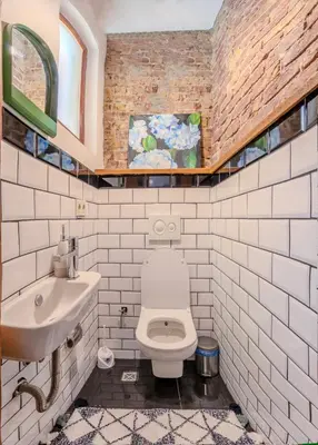 a bathroom with a white toilet and a sink at Historic Spacious Galata Apartment in Istanbul