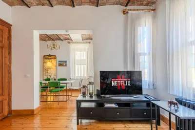 a living room with a tv on top of a table at Historic Spacious Galata Apartment in Istanbul