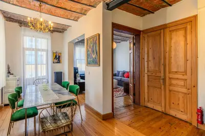 a dining room with a table and green chairs at Historic Spacious Galata Apartment in Istanbul