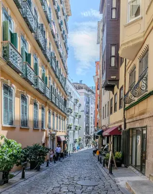 a cobblestone street in a city with buildings at Historic Spacious Galata Apartment in Istanbul