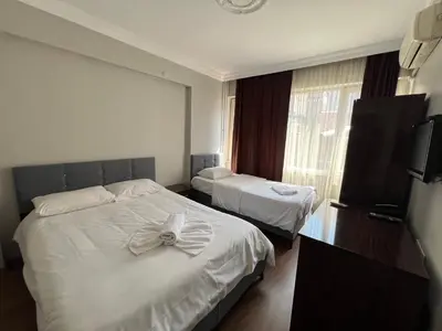 a hotel room with two beds and a window at Falay Hotel Yavuz in Istanbul