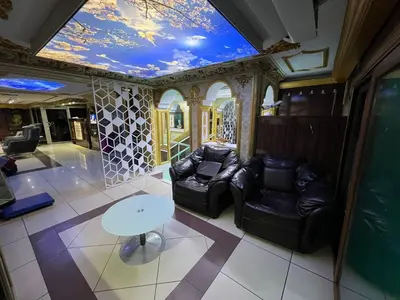 a living room with two leather chairs and a table at Falay Hotel Yavuz in Istanbul