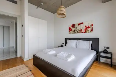 a bedroom with a large bed with white walls at Beautiful Elegant 1BD Private Terrace Gem! #333 in Istanbul