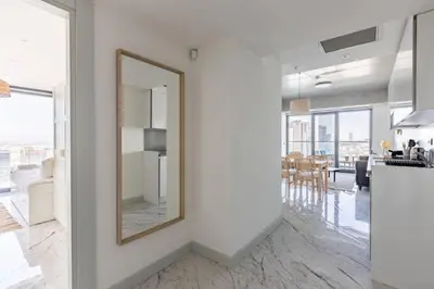 a mirror on a wall in a room with a kitchen at Beautiful Bright 2Bed - ParkingPoolTerrace! #341 in Istanbul