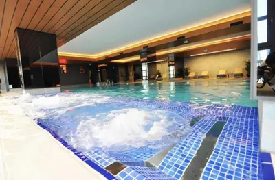 a large pool of water in a hotel at Beautiful Bright 2Bed - ParkingPoolTerrace! #341 in Istanbul