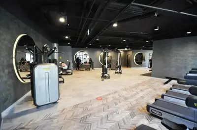 a gym with rows of exercise equipment in a room at Beautiful Bright 2Bed - ParkingPoolTerrace! #341 in Istanbul
