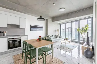 a kitchen and living room with a table and chairs at Elegant 1BD Terrace Gem PoolParking! #344 in Istanbul