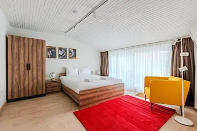 a bedroom with a bed and a red rug at Cozy New Penthouse 1BD Nisantasi Terrace Gem! #334 in Istanbul