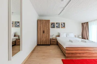 a bedroom with a white bed and a red rug at Cozy New Penthouse 1BD Nisantasi Terrace Gem! #334 in Istanbul