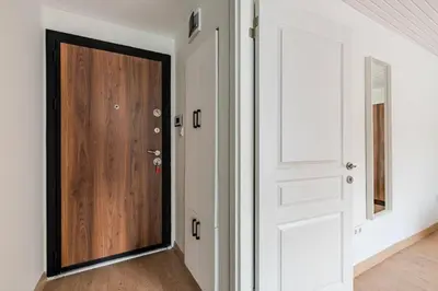 a wooden door in a room with white walls at Cozy New Penthouse 1BD Nisantasi Terrace Gem! #334 in Istanbul