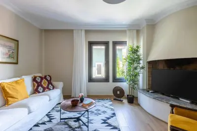 a living room with a white couch and a tv at Stunning Bosphorus 2BD2Bath Views Terrace! #357 in Istanbul