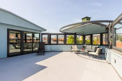 a large deck with chairs and a table on a building at Stunning Bosphorus 2BD2Bath Views Terrace! #357 in Istanbul