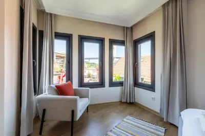 a living room with a chair and some windows at Gorgeous Airy 2BD2Bath Bosphorus Views! #358 in Istanbul