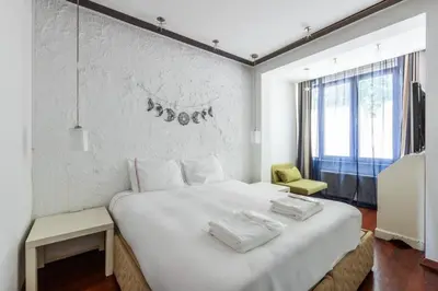 a bedroom with a large white bed and a yellow chair at Gorgeous Bright 2Bed1Bath Bosphorus Views! #356 in Istanbul