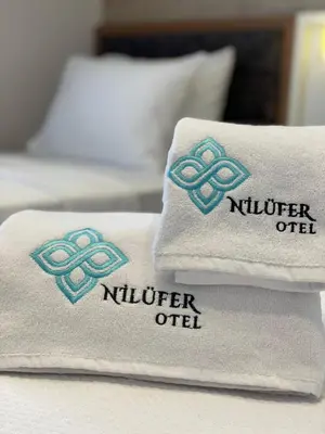 two towels sitting on top of a bed at By Otel Nilüfer in Bursa