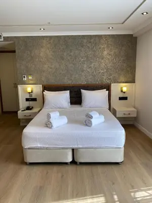 a bedroom with a bed with two towels on it at By Otel Nilüfer in Bursa