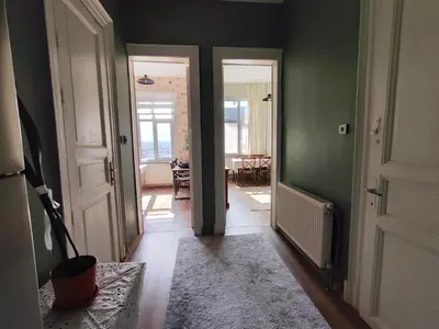 a hallway with green walls and an open door at Sweet Home in Istanbul