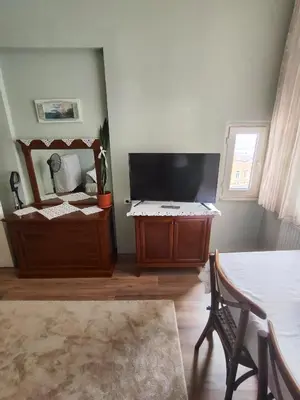 a living room with a large mirror and a table at Sweet Home in Istanbul