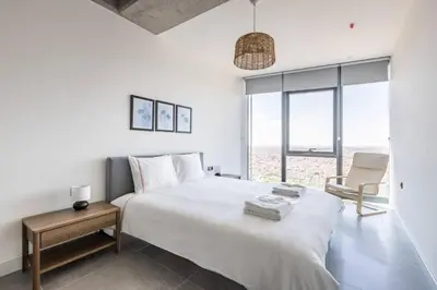 a white bedroom with a large bed and a chair at Gorgeous Bright Cool 1BD Residence Views! #359 in Istanbul