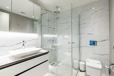 a white bathroom with a sink and a shower at Gorgeous Bright Cool 1BD Residence Views! #359 in Istanbul