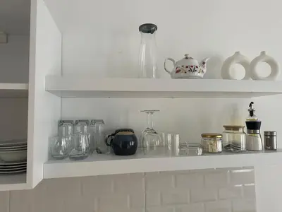a shelf with glass jars and vases on it at Yellowhouse Room 4 in Istanbul
