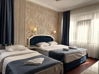 a hotel room with two beds and a window at Istanbul Allyon Hotel Taxim City Center in Istanbul