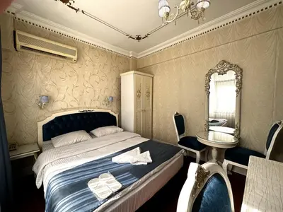 a bedroom with a bed and a mirror and a table at Istanbul Allyon Hotel Taxim City Center in Istanbul