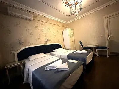 two beds in a hotel room with towels on them at Istanbul Allyon Hotel Taxim City Center in Istanbul