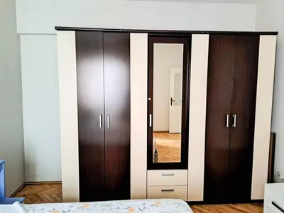 a bedroom with a large mirror and brown cabinets at Spacious and Bright Apartment - Dirim House in Istanbul