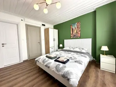 a bedroom with green walls and a large bed at Yellowhouse Room 5 in Istanbul