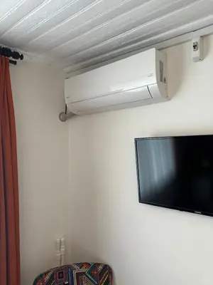 a flat screen tv hanging on a wall at Yellowhouse Room 5 in Istanbul
