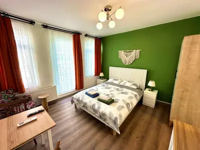a bedroom with green walls and a bed and a table at Yellowhouse Room 6 in Istanbul