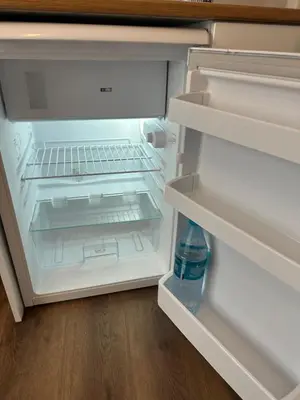 an open refrigerator with a bottle of water in it at Yellowhouse Room 6 in Istanbul