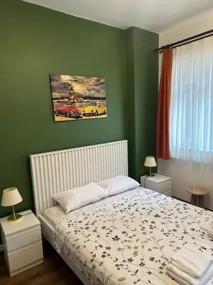 a bedroom with a bed and green walls at Yellowhouse Room 2 in Istanbul