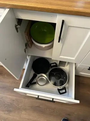 an open cabinet with pots and pans in it at Yellowhouse Room 2 in Istanbul