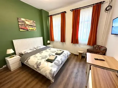 a small bedroom with a bed and a desk at Yellowhouse Room 2 in Istanbul