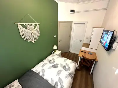 a room with a bed and a television in it at Yellowhouse Room 1 in Istanbul