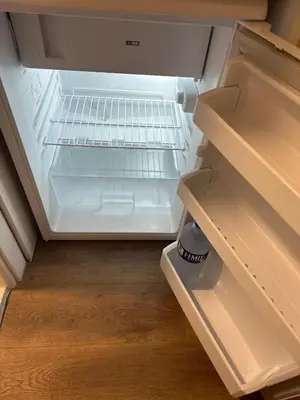 an empty refrigerator with its door open in a kitchen at Yellowhouse Room 1 in Istanbul